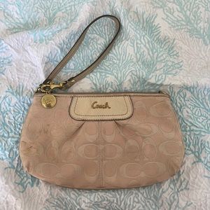 Pinkish white coach wristlet.
